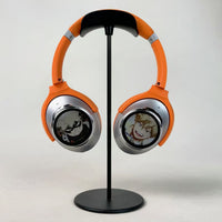 Orange and silver Dual-Screen headphones on a display stand